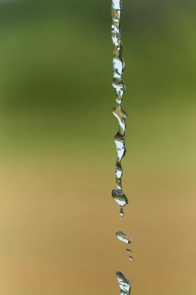 a drop of water falling from a faucet