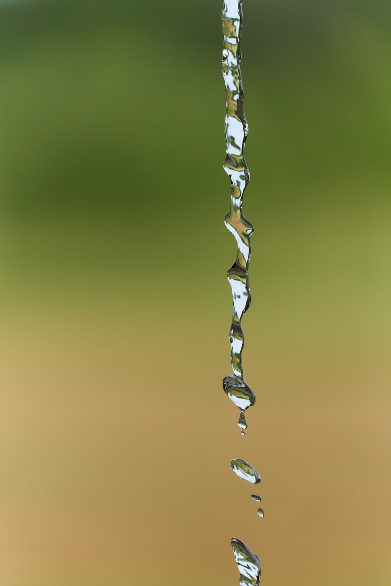 a drop of water falling from a faucet