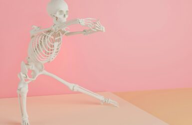 a skeleton is dancing on a pink background